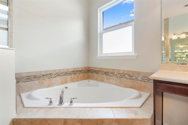 bathroom with a bath, visible vents, and vanity