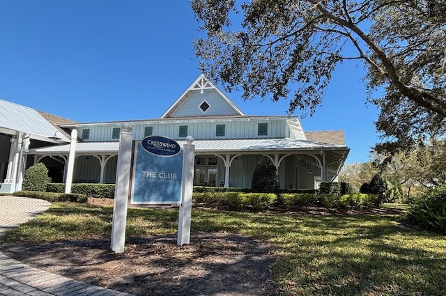 view of front facade featuring board and batten siding and a front yard