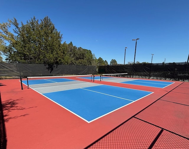 view of sport court featuring community basketball court and fence