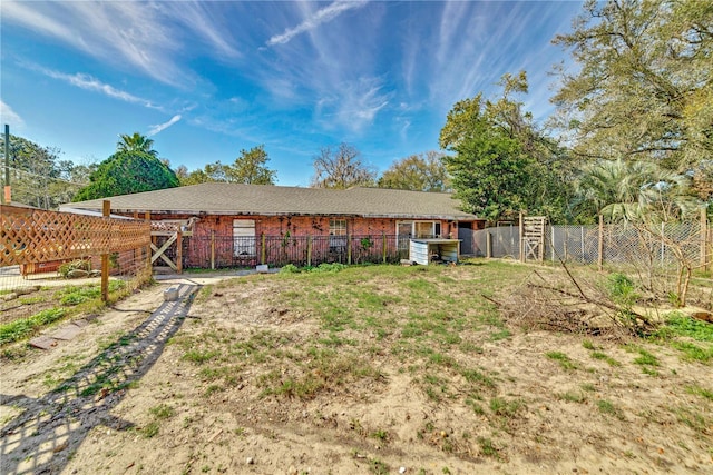 back of house with fence and brick siding