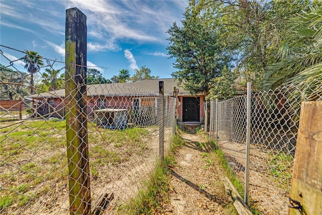 back of property with brick siding and fence