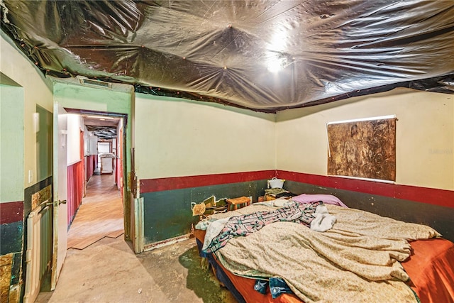 bedroom featuring unfinished concrete flooring