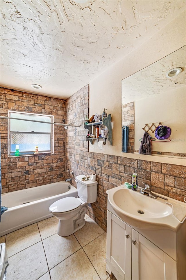 bathroom featuring toilet, tile patterned floors, a textured ceiling, vanity, and shower / bathing tub combination