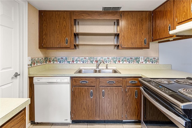 kitchen with dishwasher, light countertops, a sink, and stainless steel range with electric cooktop