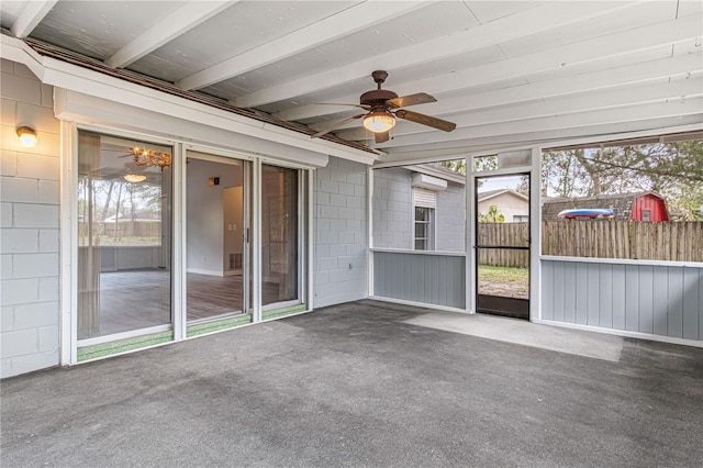 unfurnished sunroom featuring ceiling fan, a wall mounted AC, and beam ceiling