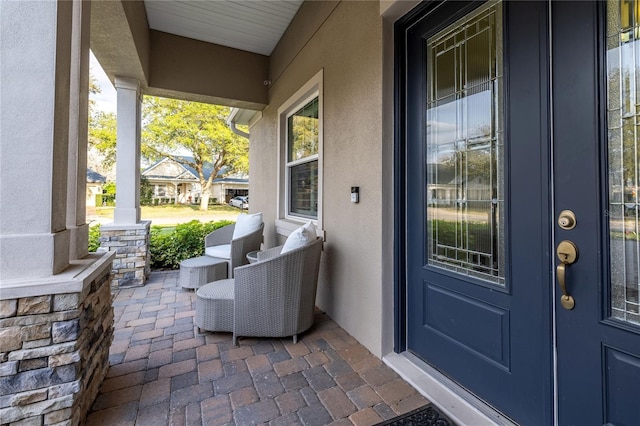 exterior space with a porch and stucco siding