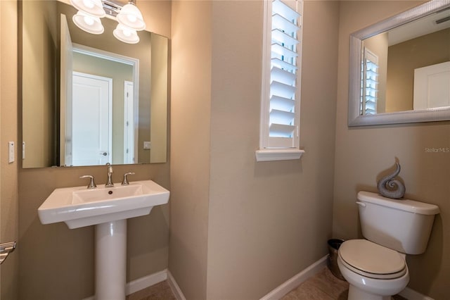 bathroom with visible vents, toilet, and baseboards