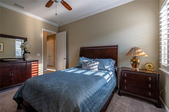 bedroom with visible vents, a ceiling fan, a textured ceiling, crown molding, and carpet floors