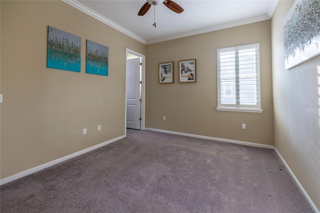 carpeted spare room featuring a ceiling fan, baseboards, and crown molding