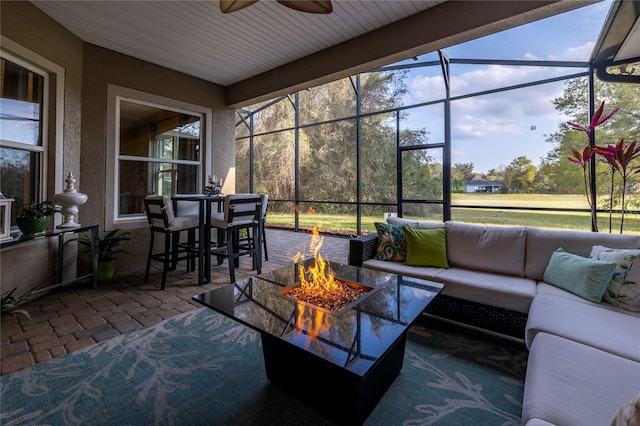 sunroom featuring ceiling fan