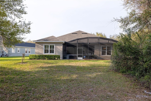 back of property with cooling unit, a sunroom, and a lawn