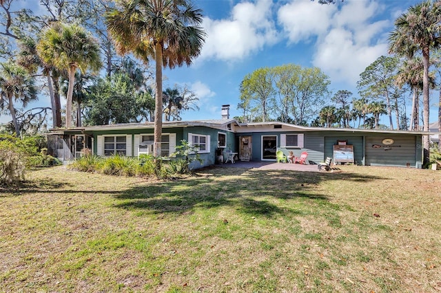 view of front of property with a chimney and a front lawn