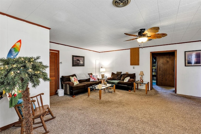 carpeted living room featuring ornamental molding, visible vents, and a ceiling fan