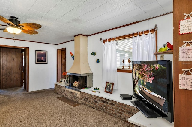 carpeted living room featuring ceiling fan, a wood stove, and crown molding