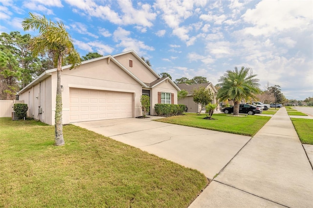 view of front of house featuring a front lawn, a garage, driveway, and stucco siding