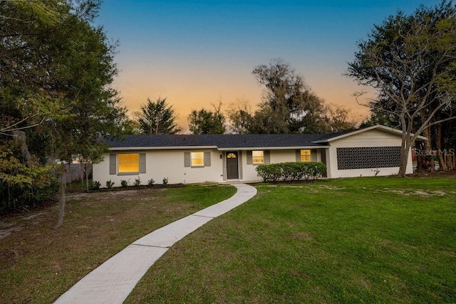 single story home featuring a front lawn