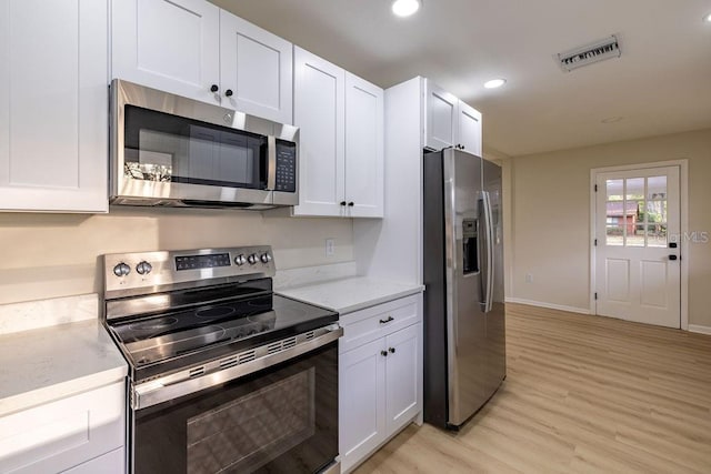 kitchen with visible vents, white cabinets, light wood-style flooring, appliances with stainless steel finishes, and recessed lighting