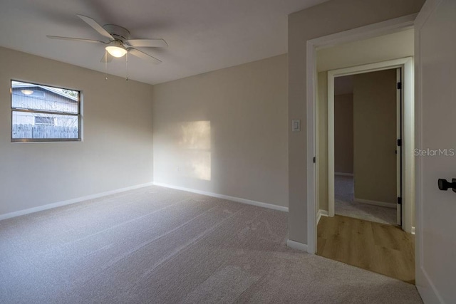 spare room featuring carpet floors, ceiling fan, and baseboards