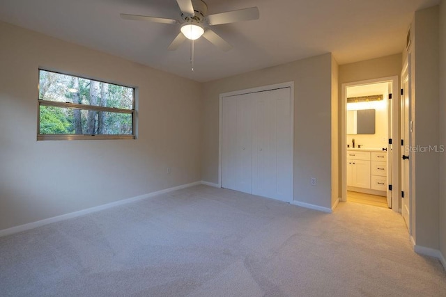 unfurnished bedroom featuring a ceiling fan, a closet, light carpet, and baseboards