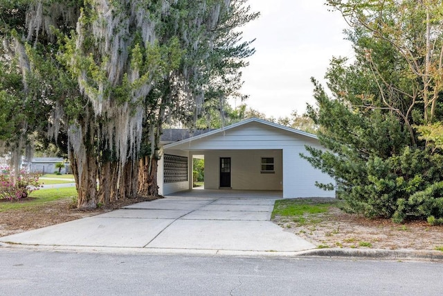 view of front of house featuring driveway and an attached carport