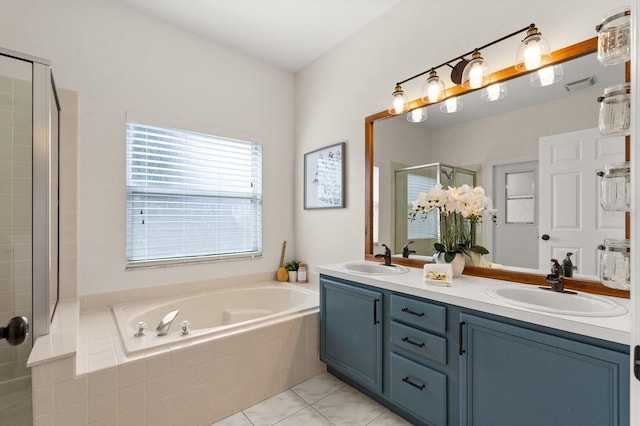 full bath with a bath, a stall shower, double vanity, and a sink