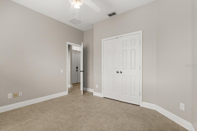 unfurnished bedroom with a closet, visible vents, baseboards, and light tile patterned flooring