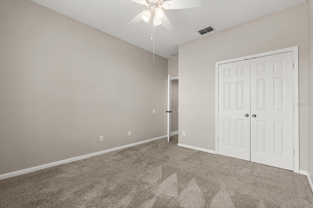 unfurnished bedroom featuring ceiling fan, carpet flooring, visible vents, baseboards, and a closet