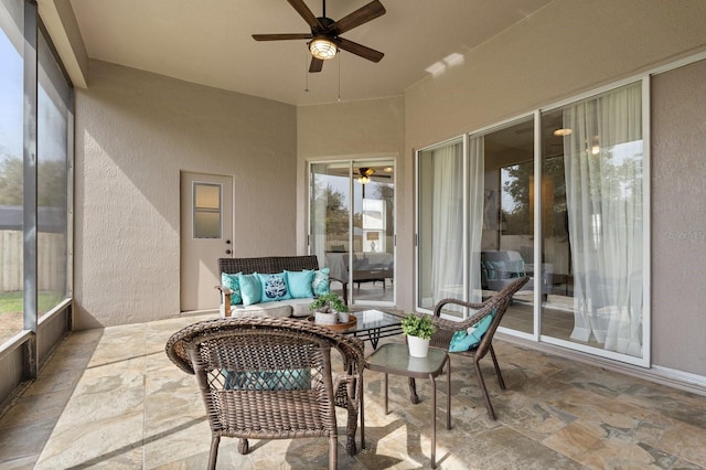 sunroom / solarium with a ceiling fan