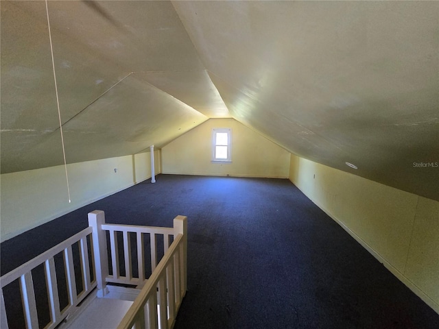 bonus room featuring lofted ceiling and carpet