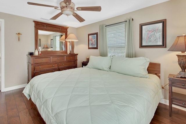 bedroom with dark wood-type flooring, visible vents, ceiling fan, and baseboards