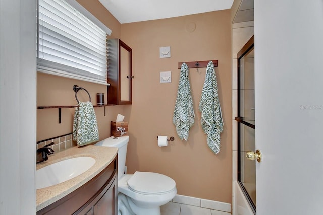 full bathroom featuring shower / bath combination with glass door, vanity, toilet, and tile patterned floors