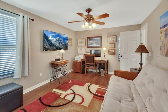 home office featuring ceiling fan, baseboards, and wood finished floors