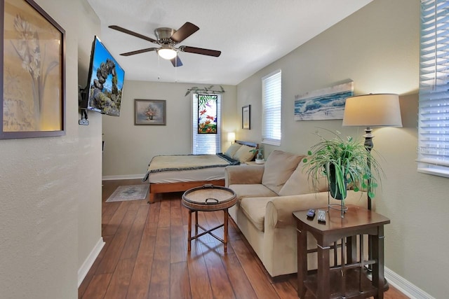 bedroom featuring a ceiling fan, baseboards, and hardwood / wood-style flooring