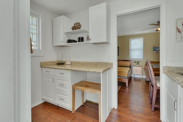 kitchen featuring light wood-style floors, white cabinets, and a ceiling fan