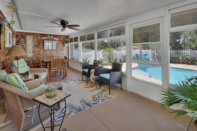 sunroom / solarium with a ceiling fan