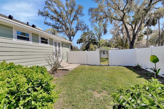 view of yard with entry steps and fence