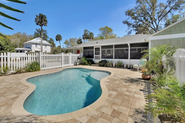 view of pool with a sunroom, a fenced backyard, a fenced in pool, and a patio