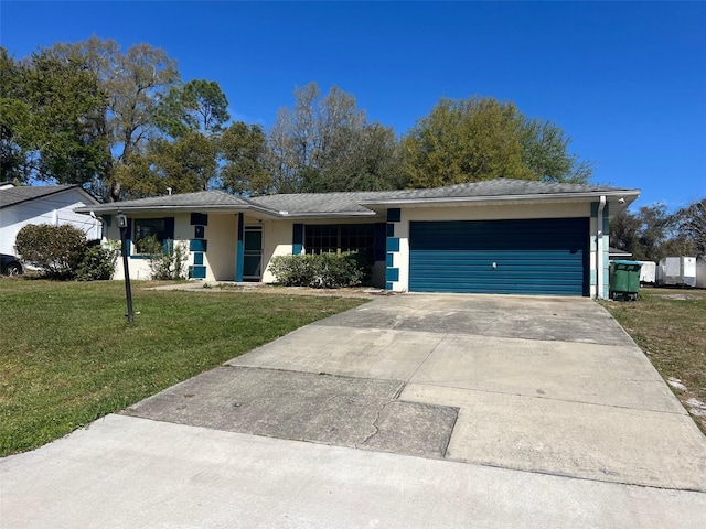 ranch-style house with an attached garage, stucco siding, concrete driveway, and a front yard