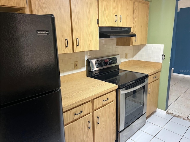 kitchen with tasteful backsplash, stainless steel electric range oven, freestanding refrigerator, under cabinet range hood, and light tile patterned flooring