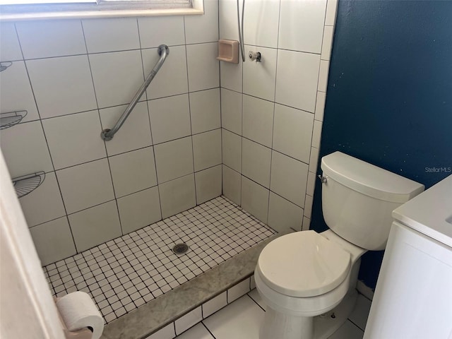 bathroom featuring toilet, a stall shower, and vanity