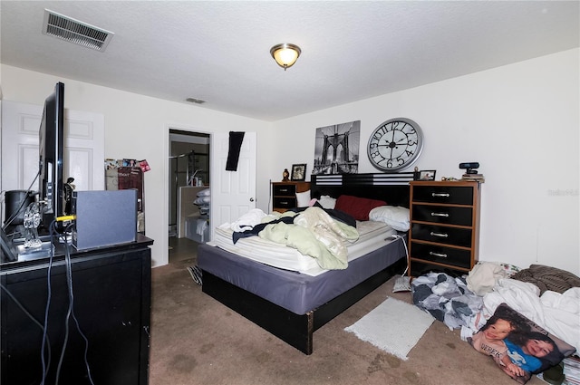 bedroom with visible vents and a textured ceiling