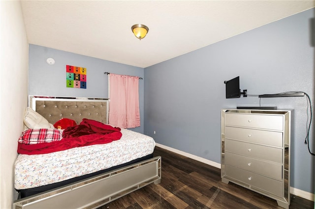 bedroom featuring wood finished floors and baseboards