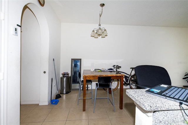 home office featuring arched walkways, light tile patterned floors, a chandelier, and baseboards