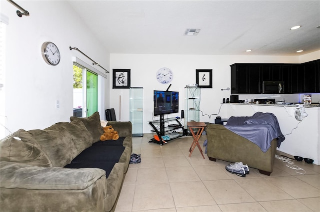 living area featuring recessed lighting, visible vents, and light tile patterned floors