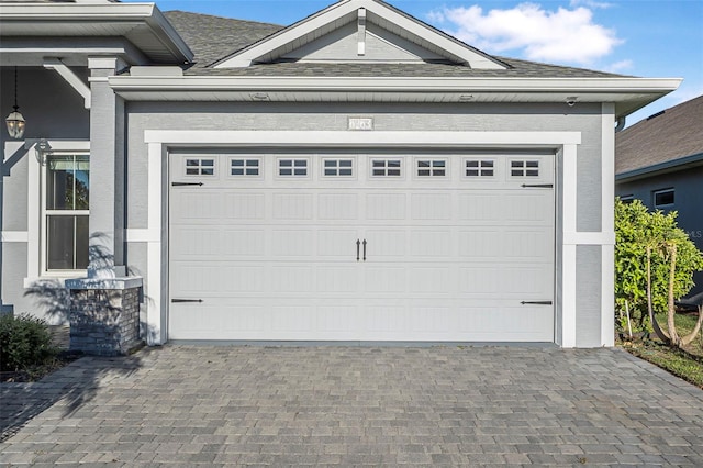 garage featuring decorative driveway