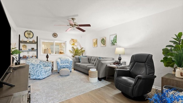 living room with a ceiling fan and wood finished floors