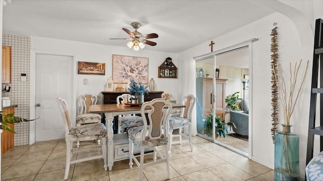 dining area featuring a ceiling fan and light tile patterned flooring