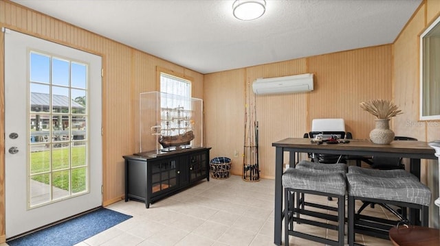 office space featuring a wall unit AC and light tile patterned floors