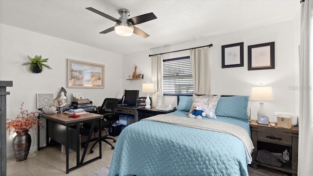 bedroom with light tile patterned floors, a ceiling fan, and a textured ceiling