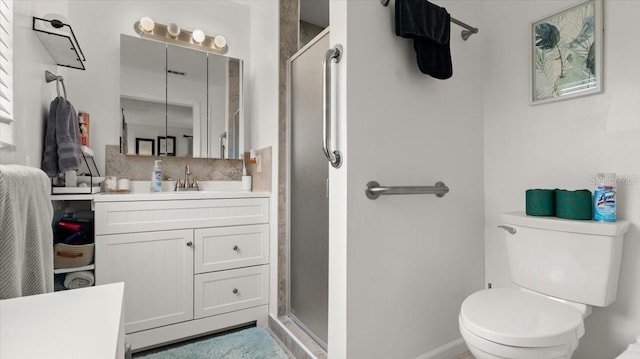 bathroom with toilet, a stall shower, vanity, and decorative backsplash